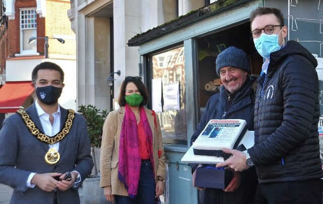 Cllr Adam Jogee, Catherine West MP, Paul Saxton, Lewis Freeman and celebratory Dunn's cake