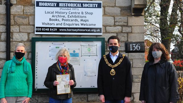 Three HHS members and the mayor outside the old schoolhouse