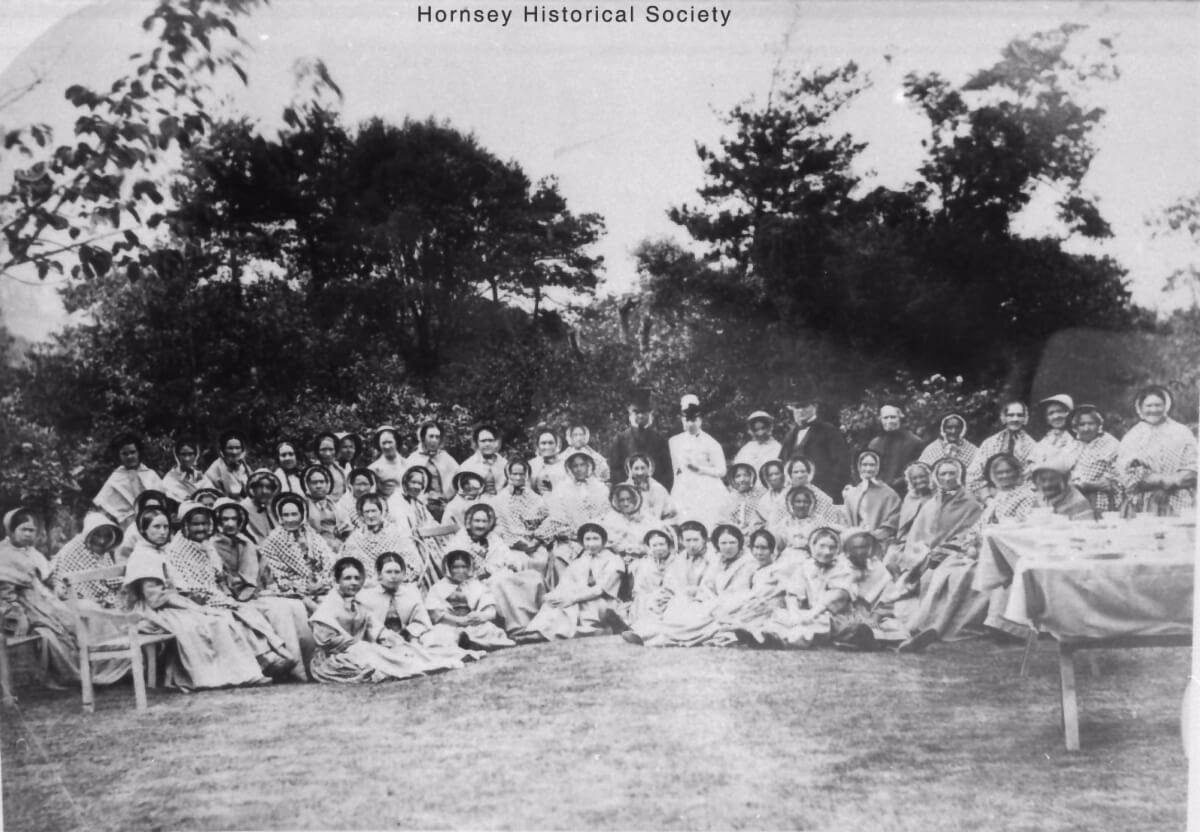 A group of women from the workhouse sitting outside