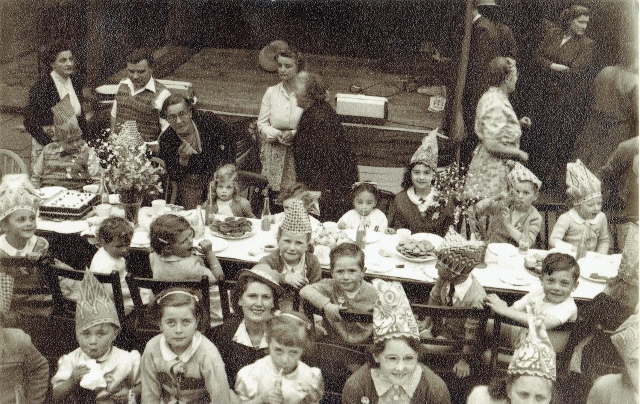 Children at eating at trestle tables at the  Coronation Street Party, Malvern Road, Turnpike Lane